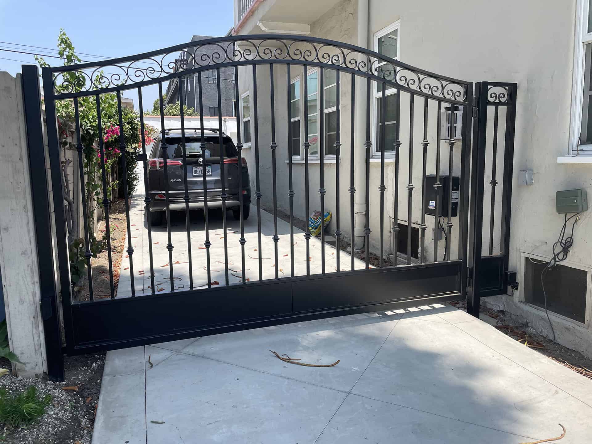 Black wrought iron arched driveway gate in Bel Air