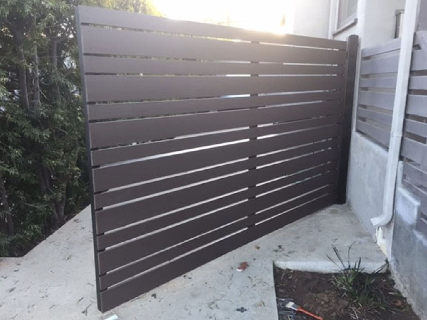 Dark brown horizontal slat fence panel