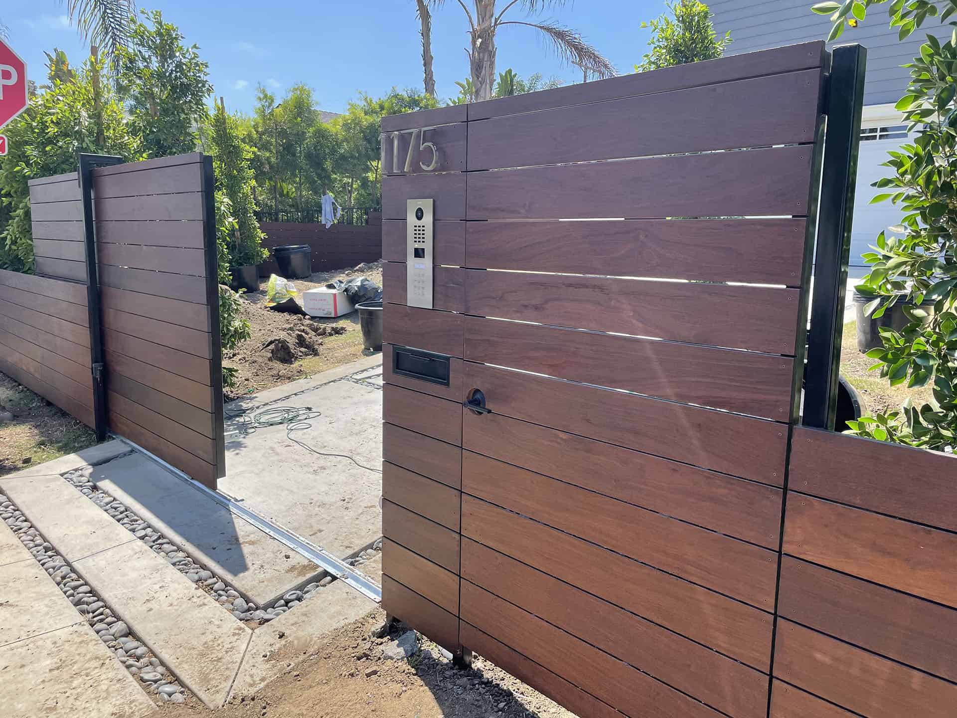 Dark walnut slat gate with video intercom