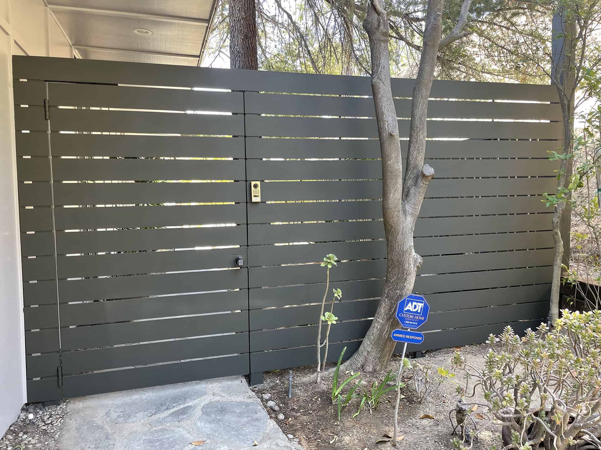 Grey horizontal slat fence with keypad gate