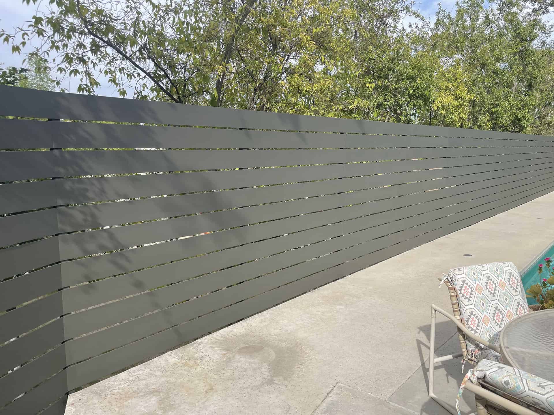 Grey horizontal slat pool privacy fence