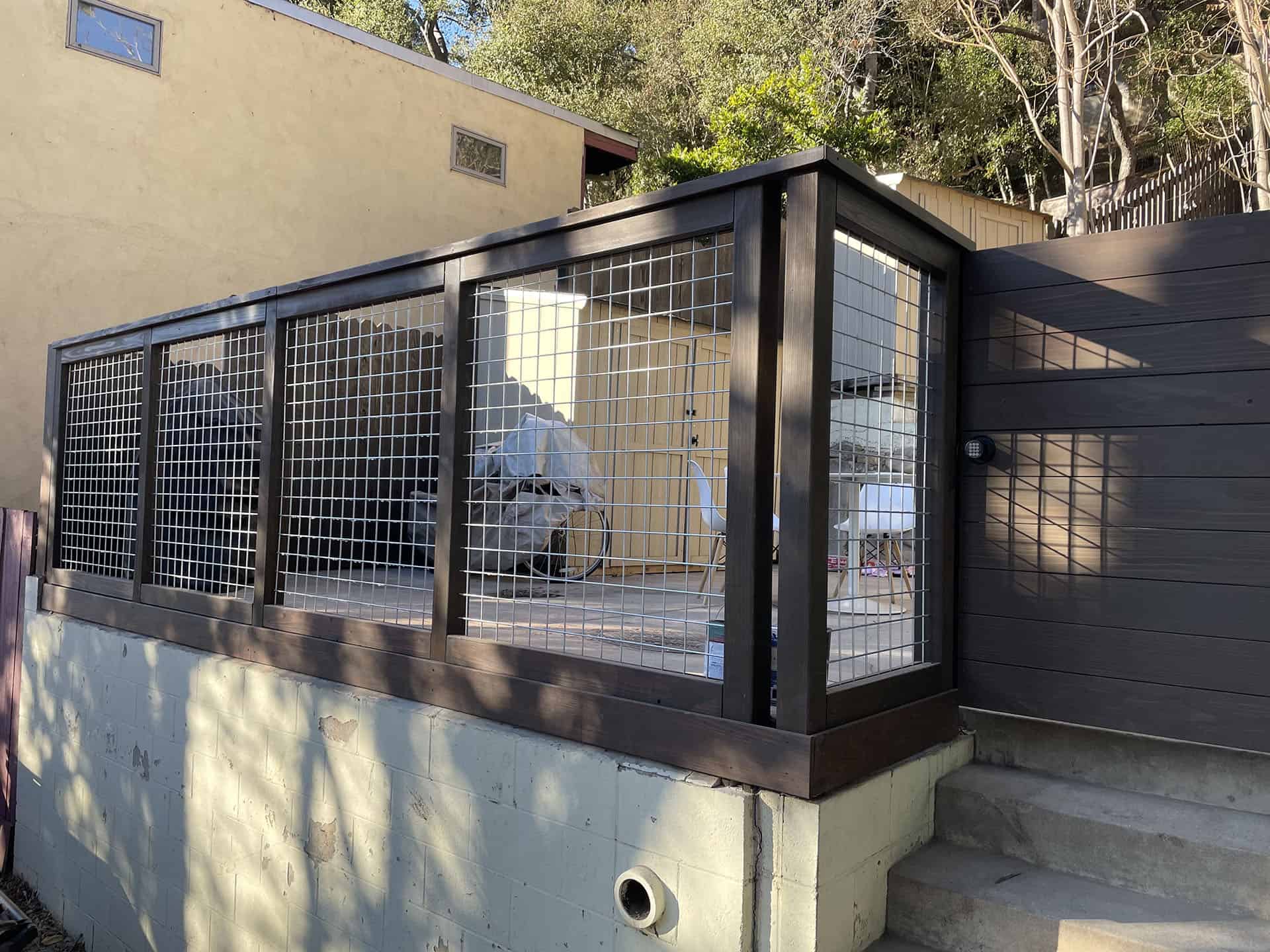 Hog wire deck railing in a dark stained wood frame