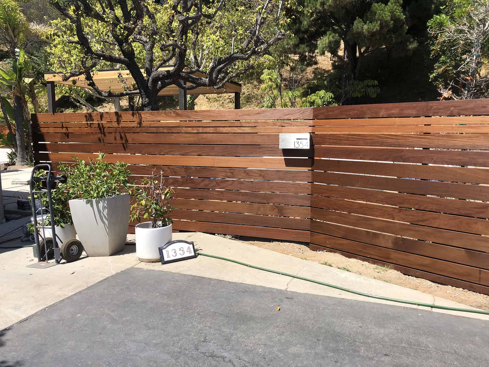 Ipe wood horizontal slat fence with an integrated mailbox