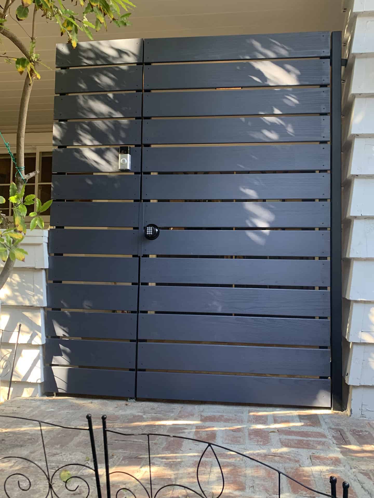 Black horizontal slat pedestrian entry gate with keypad lock